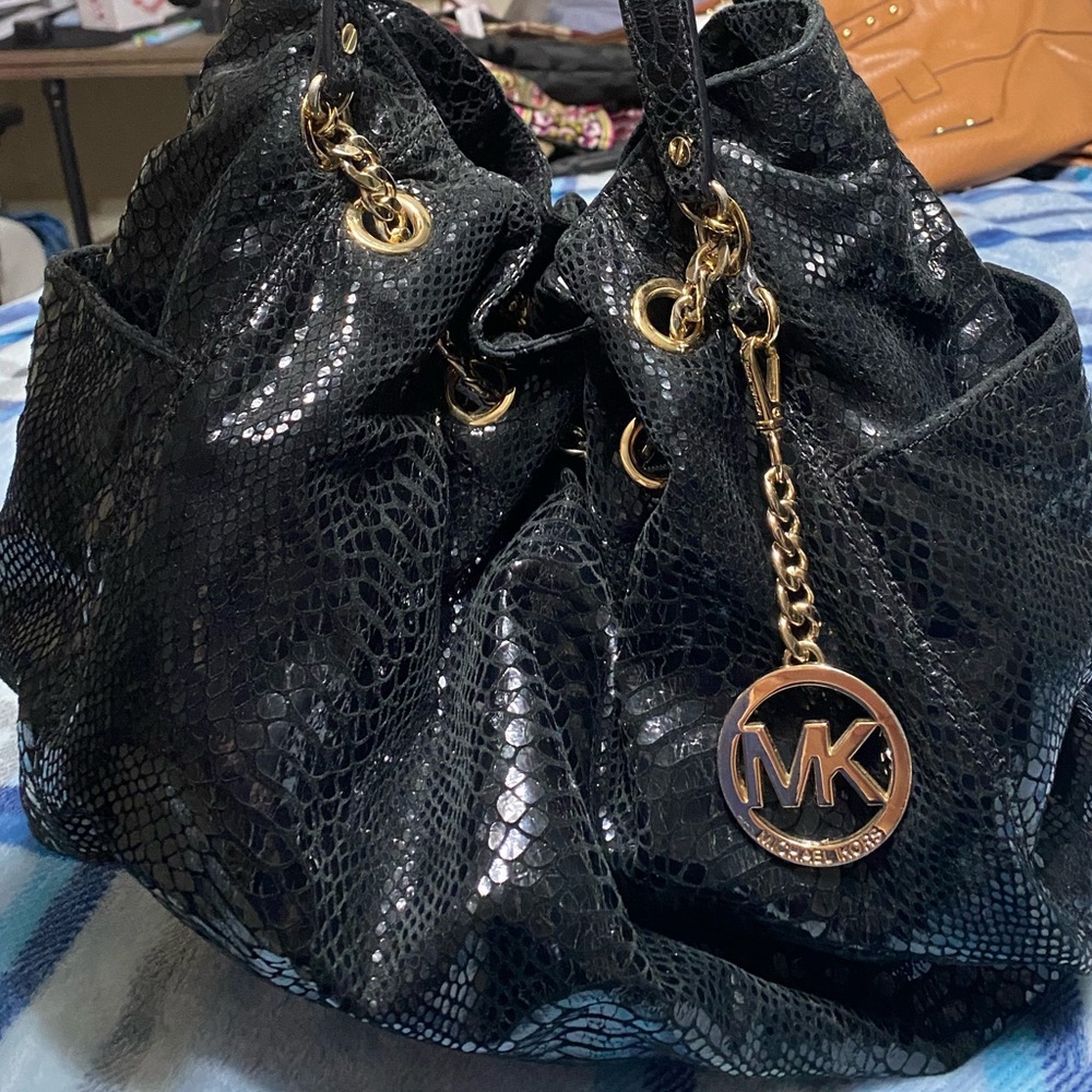 This is a Michael Kors Black Snakeskin purse.